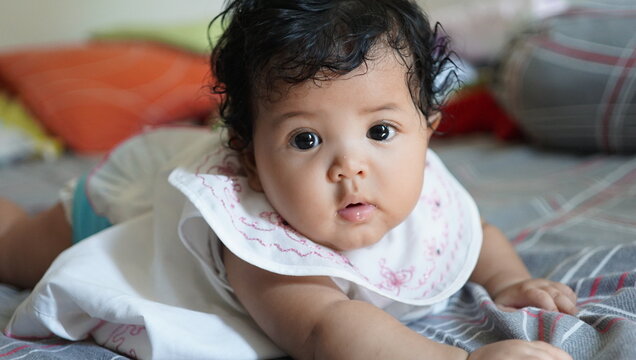 baby lying on bed