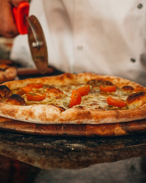 Chef cutting a pizza