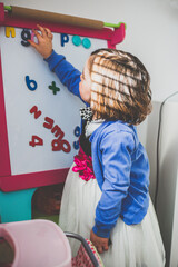 Girl learning letter and numbers