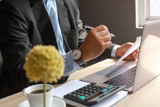 Man in blazer sitting in an office