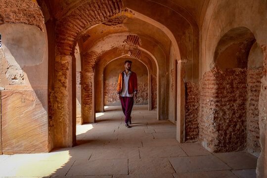 Man in traditional outfit standing in hallway