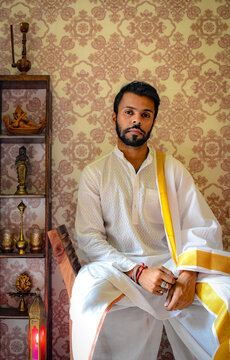 Man in white thobe sitting on chair indoor