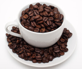 White cup filled with coffe beans