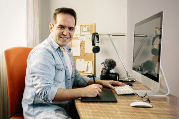 Man sitting on chair in front of laptop computer