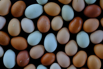 Group of earthy chicken eggs, fresh farm food grown organic free range in natural colors for background.