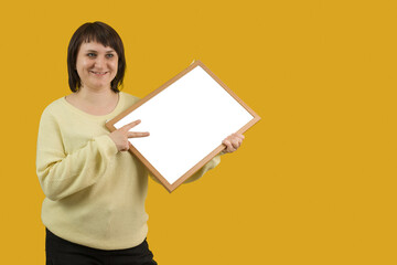 woman holding white board on yellow background