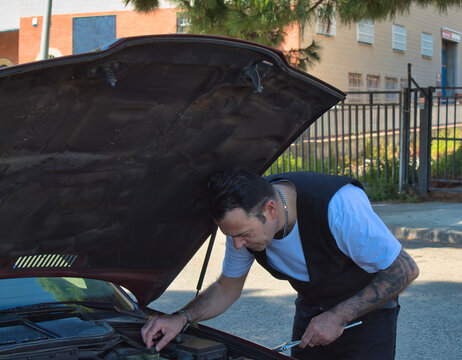 Mechanic fixing car engine
