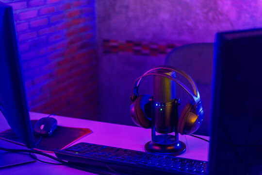 Microphone and headphones beside computer in a studio