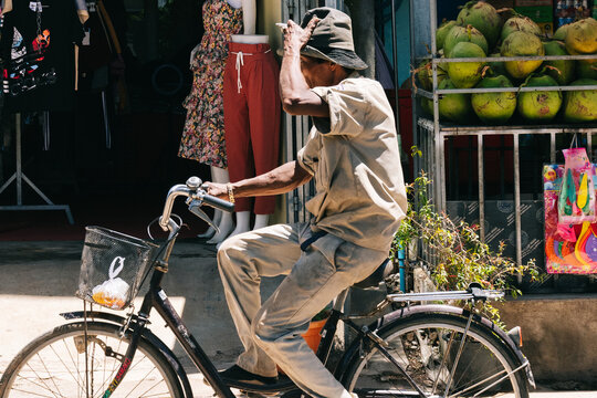 Older man riding a bike in Phnom Pehn, Cambodia