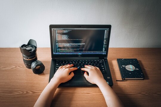Person coding on a laptop
