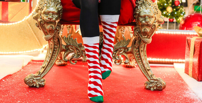 Person in Christmas themed socks sitting on chair