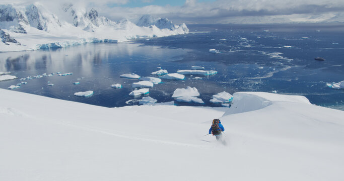 Person skiing on snowy field beside sea