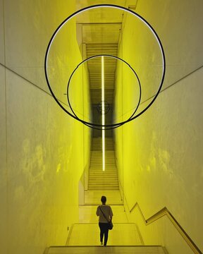 Person walking in a yellow staircase