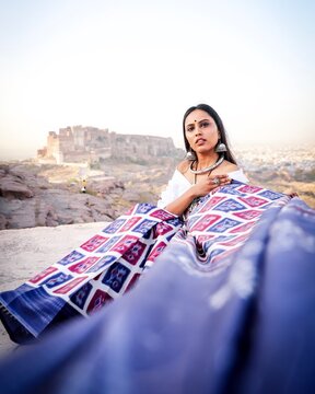 Portrait of woman holding decorative fabric outdoors