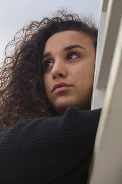 Portrait of woman leaning on rail