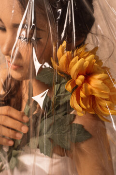 portrait of woman pitting flowers on her shoulder