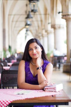 Portrait of woman sitting at a table in restaurant during daytime