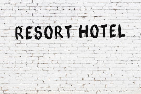 White wall with black paint inscription resort hotel on it
