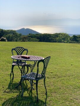 two chairs and tables on green grass