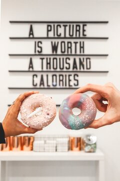 Two doughnuts with text saying "A picture is worth a thousand calories" in the background