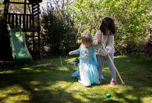 Two girls playing in the backyard of their house