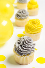 Tasty cupcakes and confetti on white background, closeup
