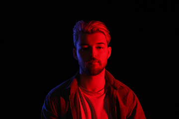 Portrait of handsome young man on dark background