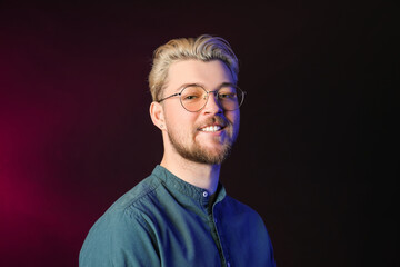 Portrait of handsome young man on dark background