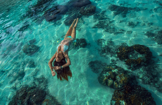 Woman in blue bikini swimming in the water