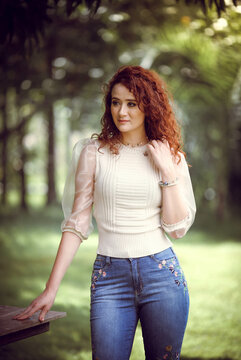 Woman in white long sleeve shirt and blue denim jeans outdoor