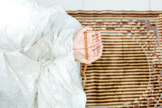 Woman praying on mat