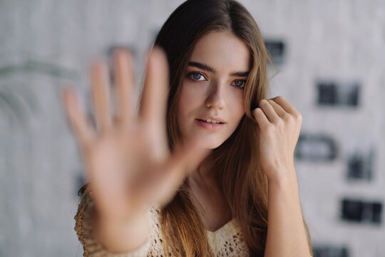 Woman showing her right palm out of focus