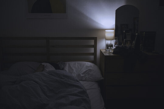 Woman sleeping in her bedroom