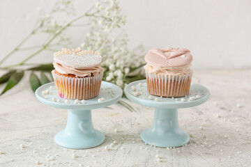 Dessert stands with tasty wedding cupcakes on table