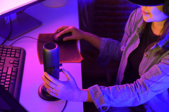Woman surrounded by cameras and microphone in a podcast studio