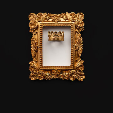 A golden baroque frame in and a royal crown on a white and black background. Vintage style template for a text, image or object to insert.