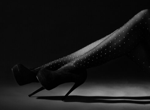 Woman wearing white dotted tights with black heels