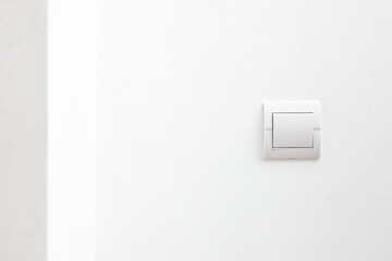 Modern light switch on white wall