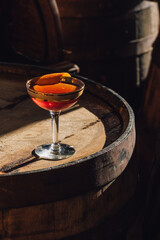 bourbon whiskey whisky Manhattan gold 60s coupe glass cocktail happy hour on barrel orange twist 