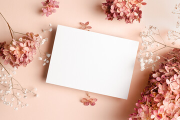 Invitation card mockup with hydrangea and gypsophila flowers decorations. Blank greeting card...