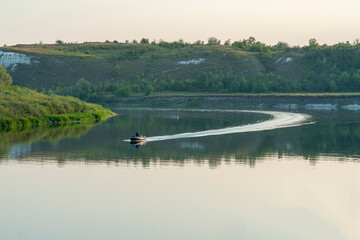 Fototapeta na wymiar a rubber motor boat floats on a large river