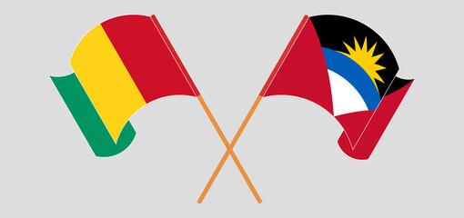 Crossed and waving flags of Guinea and Antigua and Barbuda