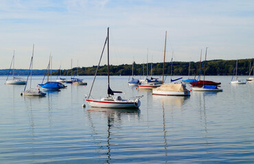 Fototapeta na wymiar a scenic view of sailing boats in the evening sun on lake Ammersee in Germany 