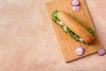 Board with tasty sandwich on color background