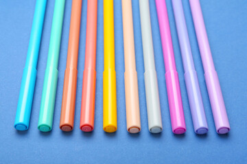 Colorful markers on color background