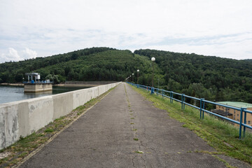 Walkway along the dam of Domaša Slovakia. To the right is a small hydroelectric power plant and to the left is a technological device to regulate the flow of water