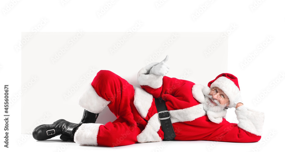 Wall mural Lying Santa Claus with blank poster on white background