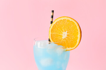 Glass of Blue Lagoon cocktail on color background