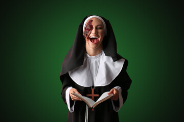Crazy woman dressed for Halloween as nun with Bible on dark color background