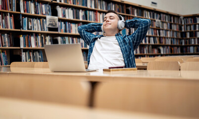 The man is enthusiastically studying at the institute. Surf the Internet in between classes. Student online lessons on the institute's website. Reads an e-book in the university library.